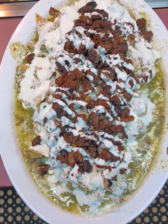 Chilaquiles Verdes - Tortilla chips in green salsa with crema; your choice of meat.